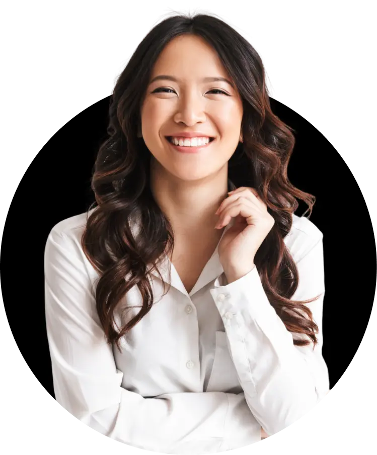 A young woman with light skin and long wavy dark hair, wearing a white blouse. She is smiling brightly and looking very cheerful.